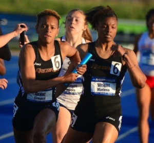 Wright (at right) hands off to anchor Simone Grant (at left) after running the 3rd leg of the 4x400M Relay at the 2014 NCAA Championships. Championships